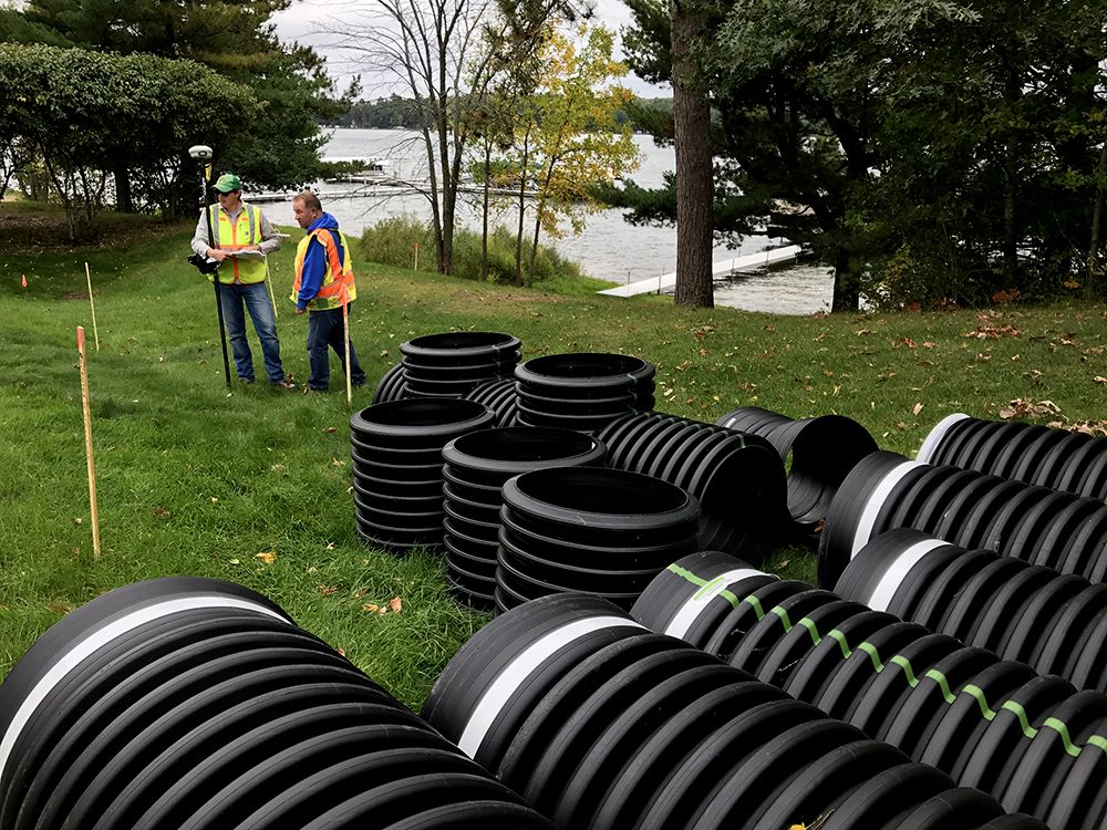 workers survey site of stormwater treatment project