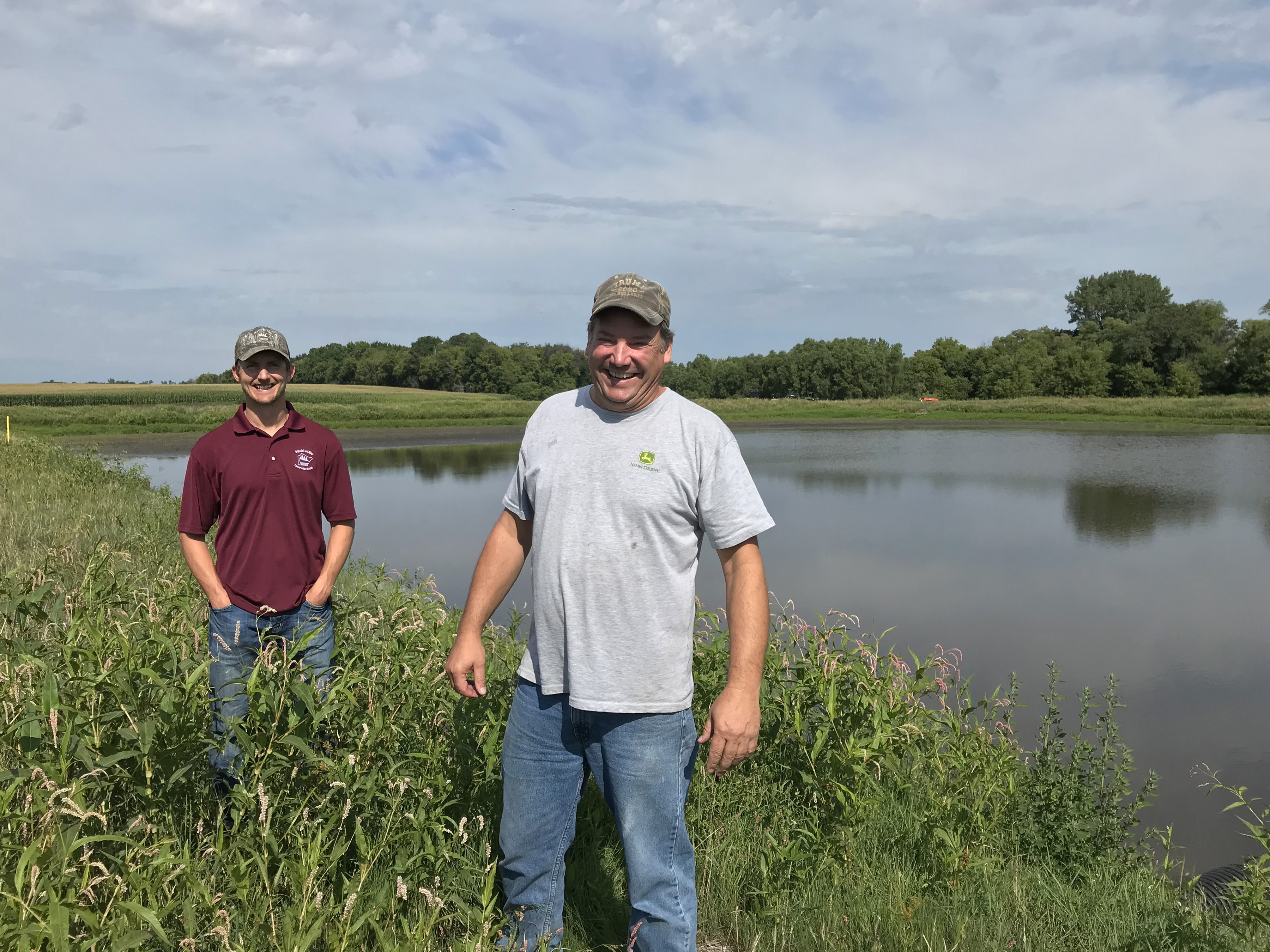 Landowner Craig Brose, right, and Wright SWCD resource conservationist Andrew Grean in front of a 10-acre pond