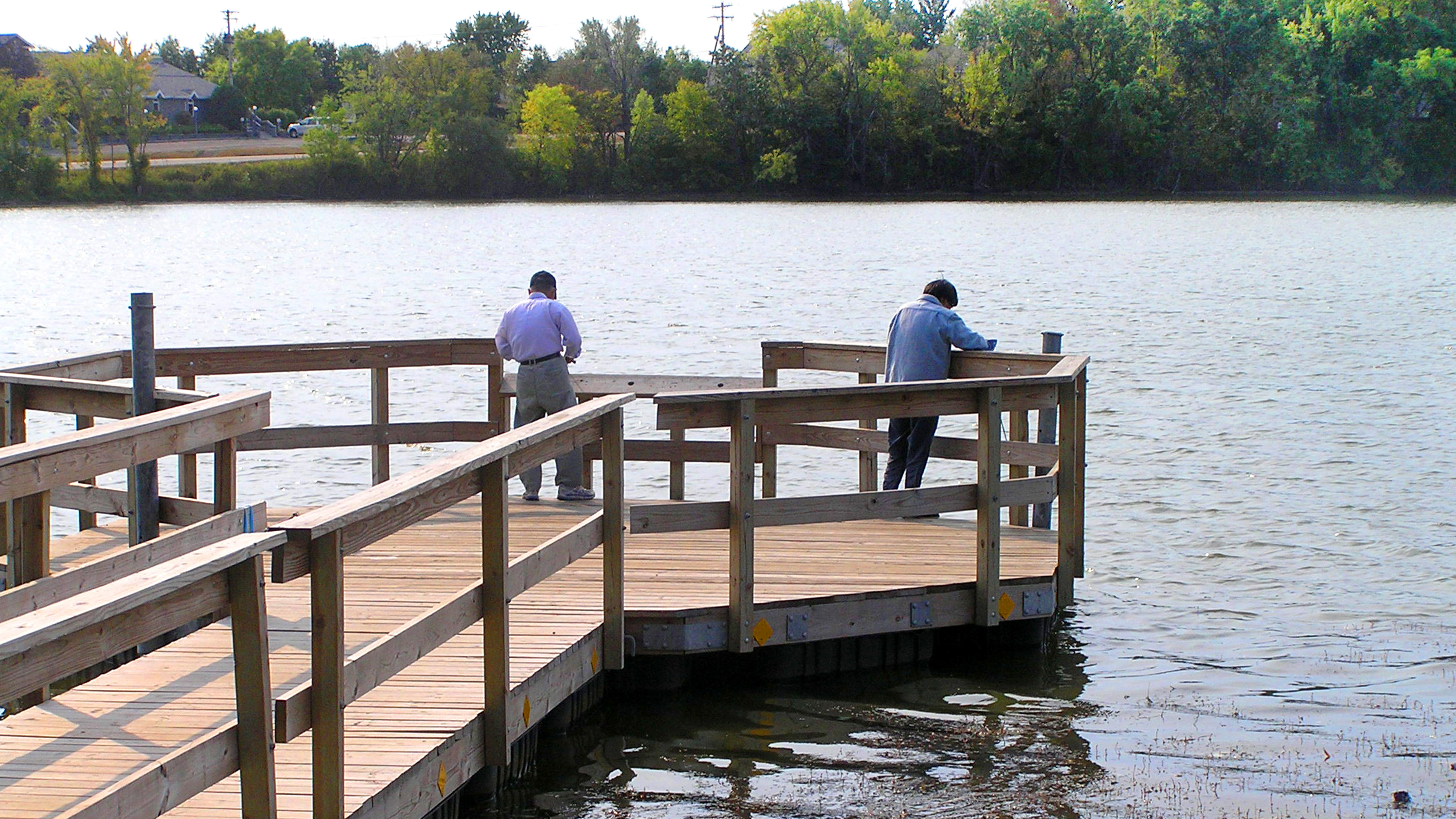 Two anglers fish from a pier on Silver Lake