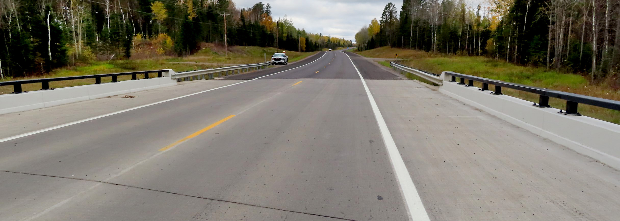 Wide shoulders flank a highway bridge crossing