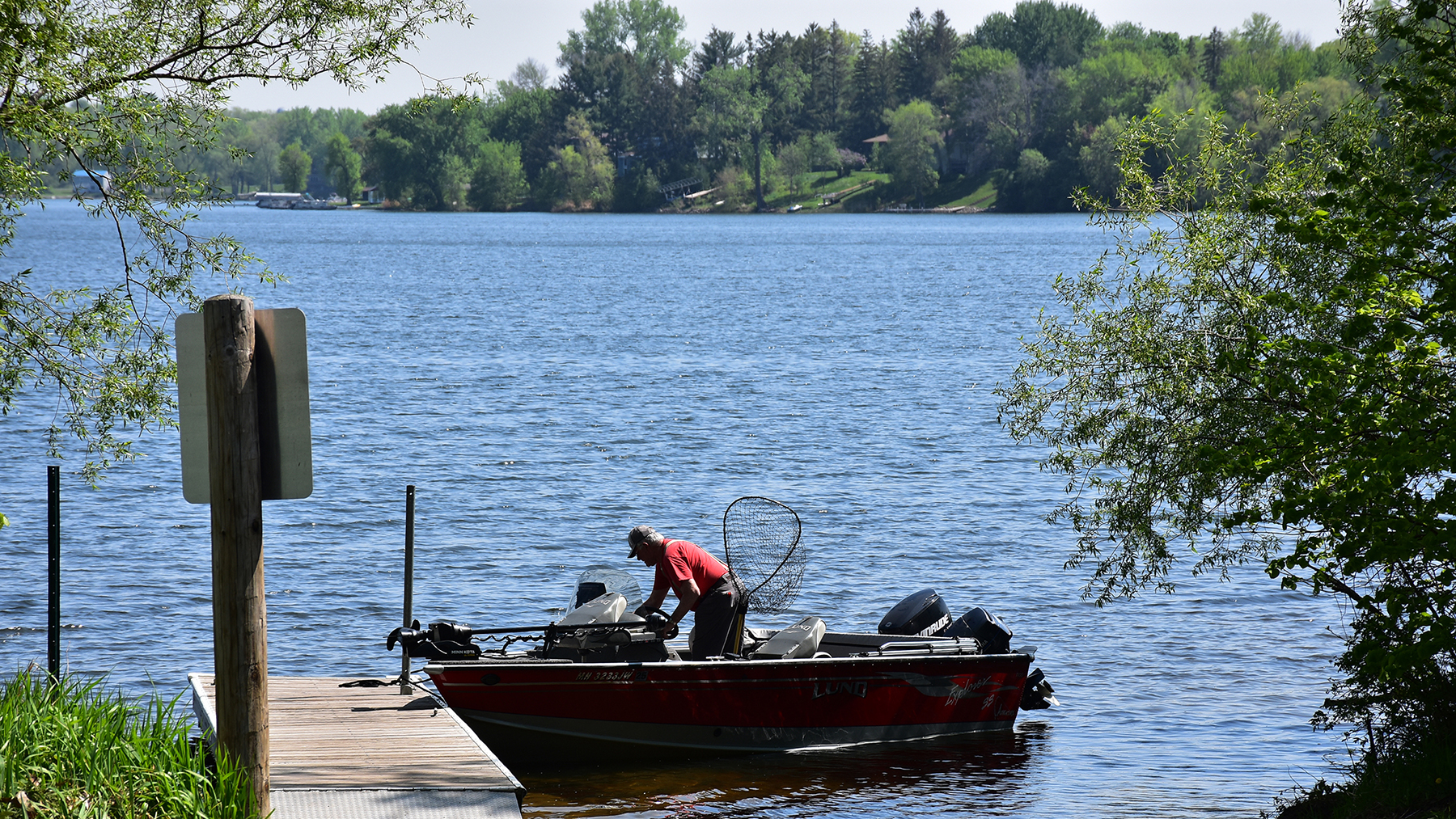 Man at dock prepares to launch boat