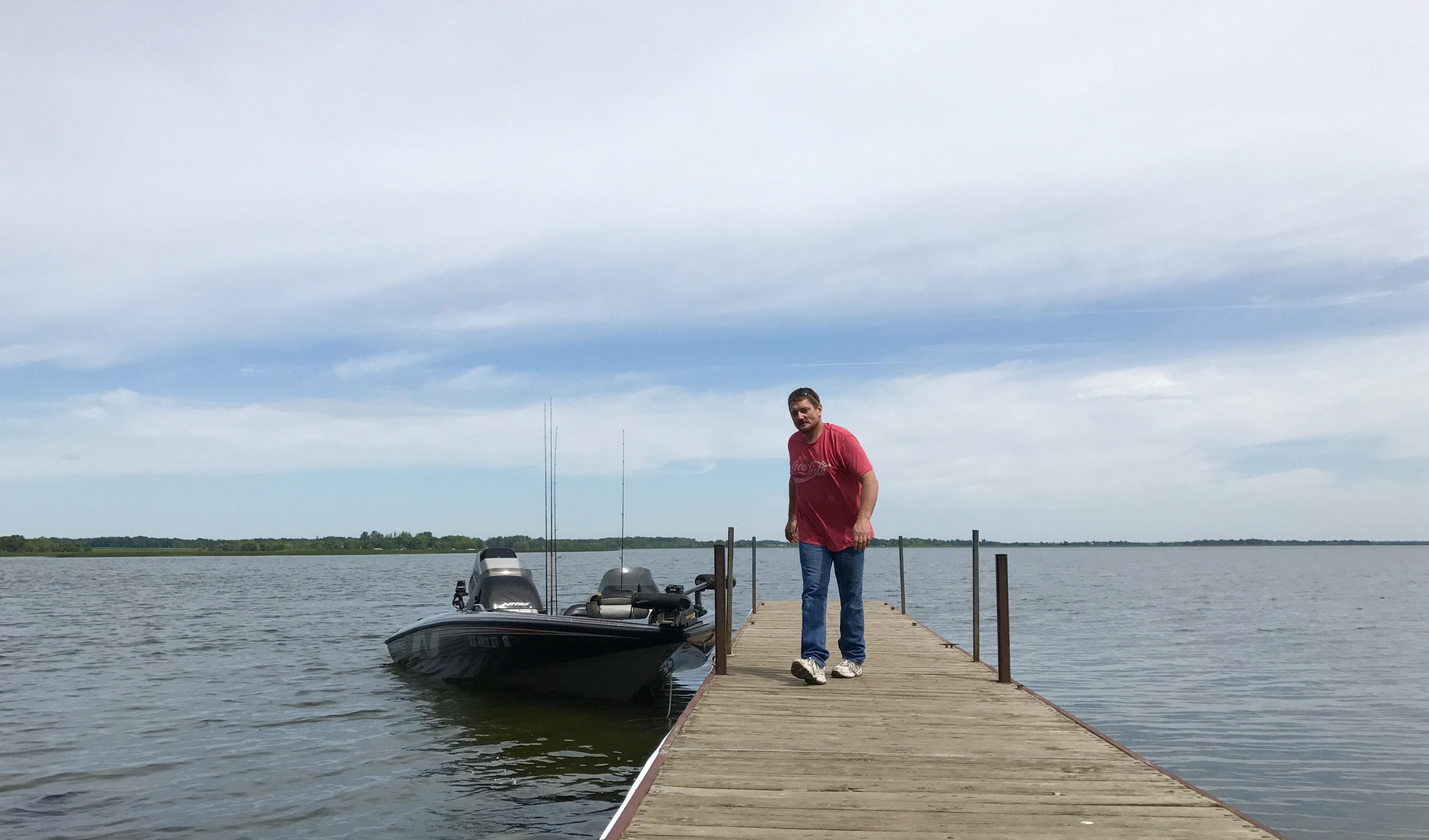 man on dock in lake