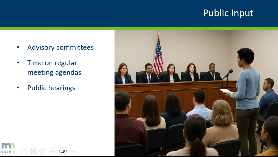 a screen shot from a video showing a public meeting and some text