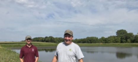 Landowner Craig Brose, right, and Wright SWCD resource conservationist Andrew Grean in front of a 10-acre pond