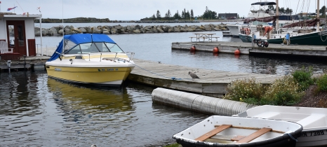 small boats on shore and tied to docks