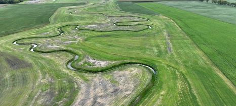 A river winds through agricultural fields