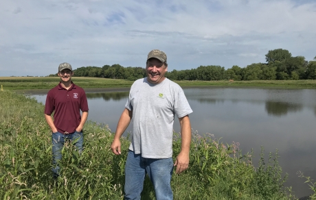 Landowner Craig Brose, right, and Wright SWCD resource conservationist Andrew Grean in front of a 10-acre pond