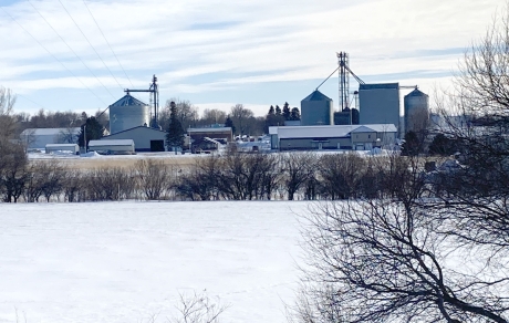 Snow covers a wellhead protection area. Adrian skyline is in the background.