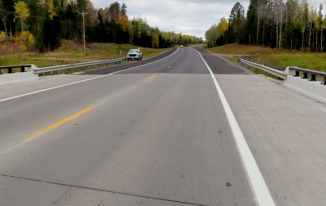 Wide shoulders flank a highway bridge crossing