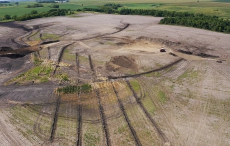 In an aerial view, trenches appear as long dark lines in a field.